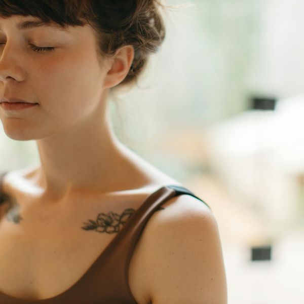 Close-up of a person breathing deeply with eyes closed, embodying tranquility.